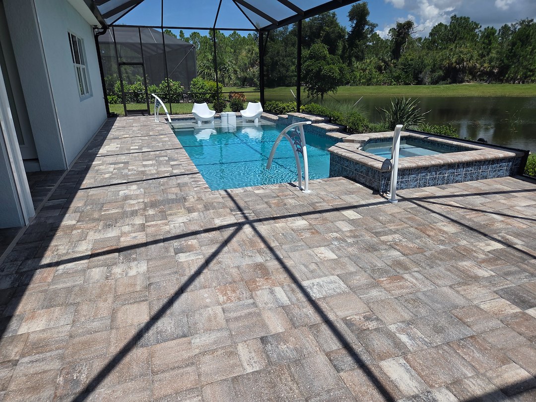 Exterior maintenance performed on this home in the Beachwalk Community of Englewood started with a softwash of the house and cage as well as driveway and pool deck paver sealing. Thumbnail