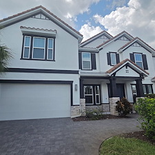 This-complete-exterior-painting-on-a-2-story-with-White-body-and-black-trim-in-the-Heron-Landing-Community-turned-out-beautiful 2