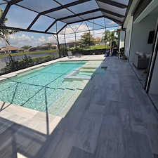 This-new-customer-in-The-Isles-of-Lakewood-Ranch-got-the-VIP-Soft-wash-on-house-and-pool-cage-Paver-Driveway-sealed-and-beautiful-Marble-Tile-Pool-Deck-Repaired-and-Restored 1