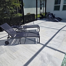 This-new-customer-in-The-Isles-of-Lakewood-Ranch-got-the-VIP-Soft-wash-on-house-and-pool-cage-Paver-Driveway-sealed-and-beautiful-Marble-Tile-Pool-Deck-Repaired-and-Restored 4